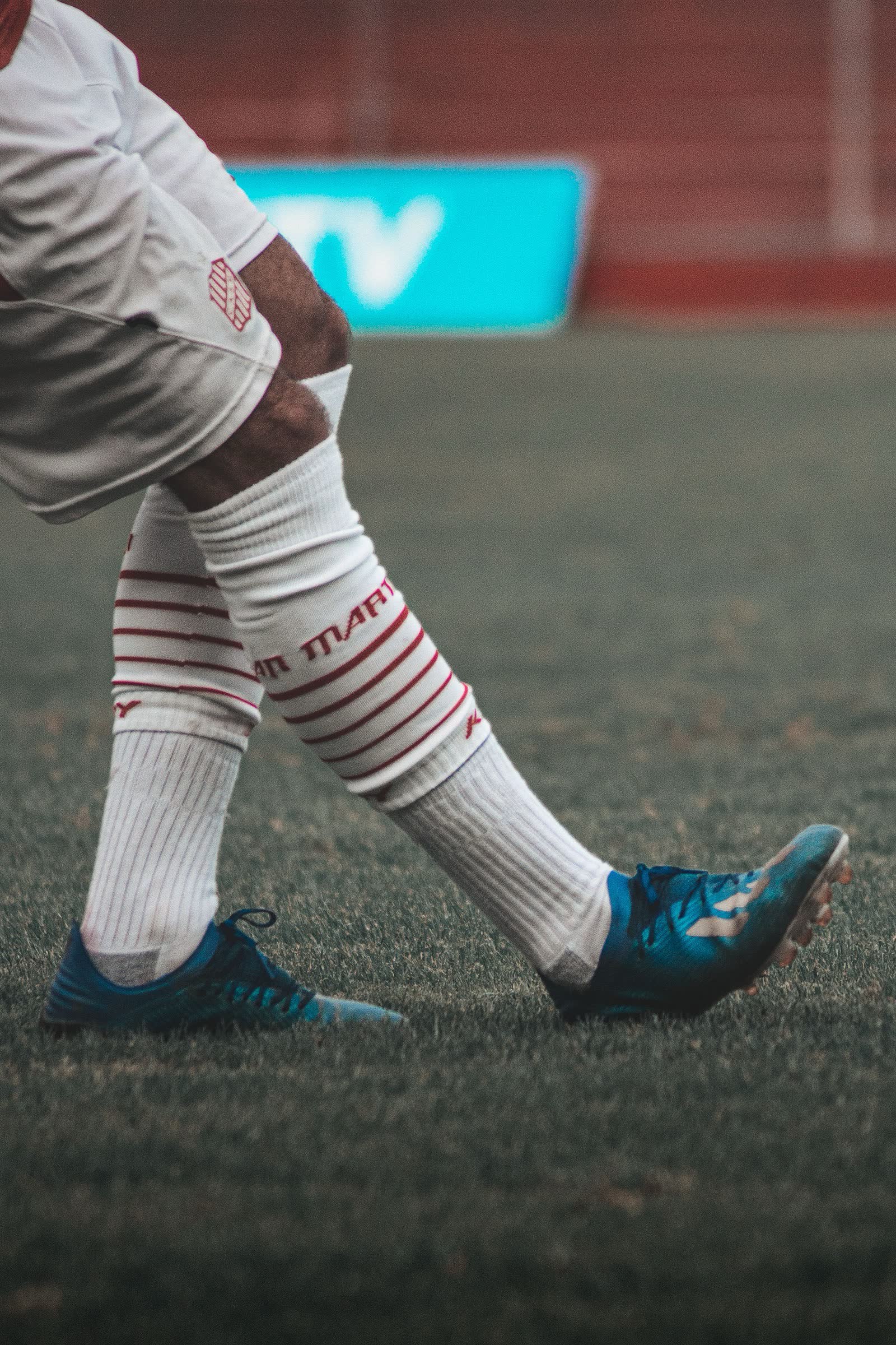 Close-up of a player in boots and socks on the pitch
