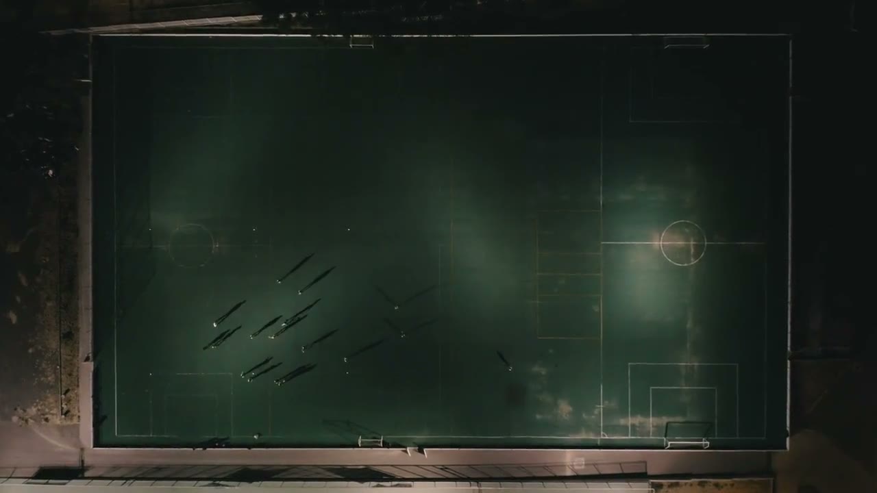 Aerial view of a floodlit pitch at night
